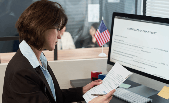 A translator stamps and signs a certified birth certificate, showing accurate Translation Services in Chattanooga.