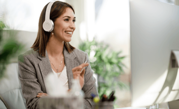 A native German transcriber types with headphones in a home office, providing affordable German Transcription Services.