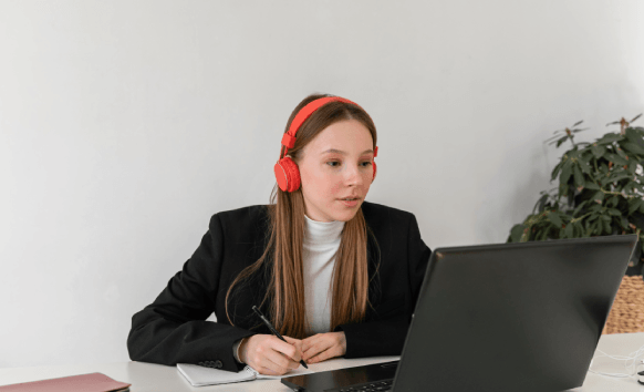 A transcriptionist uses headphones and a laptop to deliver Police Transcription Services with affordable pricing for reports.