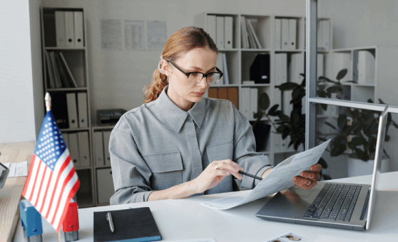 A translator proofreads a certified page with deadline notes, emphasizing fast, affordable Translation Services in Fargo.