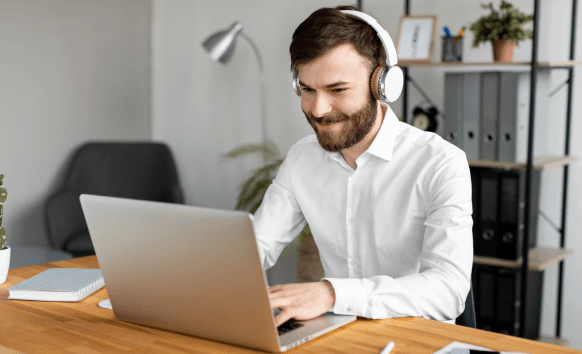 A customer uses a laptop to view a checkout page showing affordable pricing for Tulsa Transcription Services.