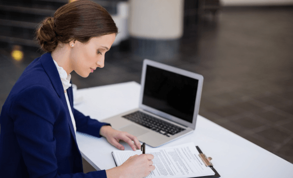 A project manager checks a bilingual contract on screen as Toledo Translation Services supports certified business documents.