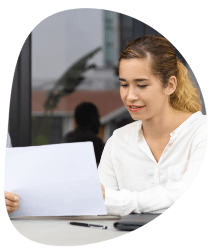 A client hands a birth certificate to a translator at an office counter, requesting Alexandria Translation Services.