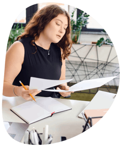 A registrar checks a certified transcript translation using Newport News Translation Services for a college transfer file.