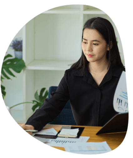 A translator types a certified translation from a handwritten letter, highlighting Expert Translation Services in Columbia.