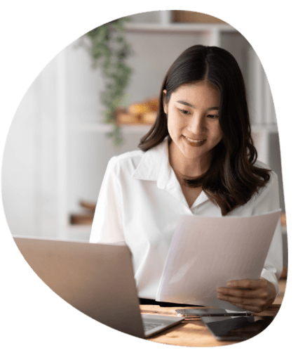 A linguist checks an SOP and quality file in a workspace, delivering Pharmaceutical Translation Services for a document.