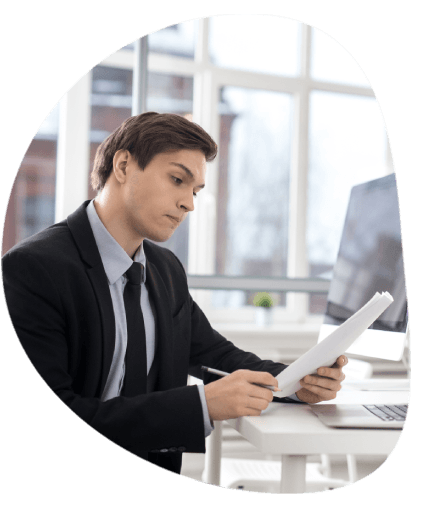 A translator works at a desk on business papers and policy handbooks for Translation Services in Hollywood other documents.