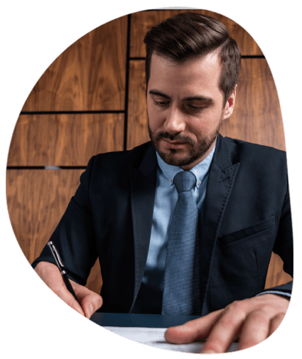 A translator stamps a certified seal on an official document at a desk, showcasing Translation Services in Norfolk.