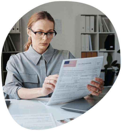 A translator formats an immigration packet as Educational Translation Services translate school records for USCIS review.