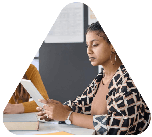 A curriculum designer edits a bilingual handout as Educational Translation Services align learning materials to standards.