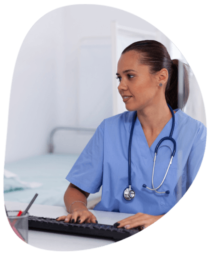 A doctor using a manual medical glossary on a laptop, supporting Pharmaceutical Translation Services with consistency.