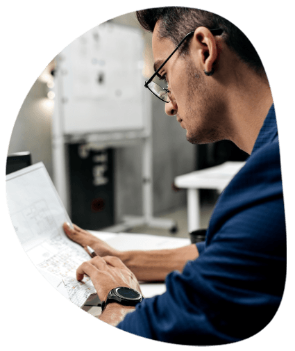 An engineer marks up a machine manual while Toledo Translation Services applies technical terminology and unit conversions.