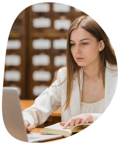 An academic translator checks citations and terminology in a quiet library, delivering Translation Services in Wichita.