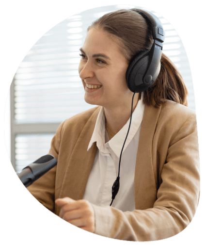A transcriber with headphones types dialogue with accents, using Media Transcription Services for media accessibility.