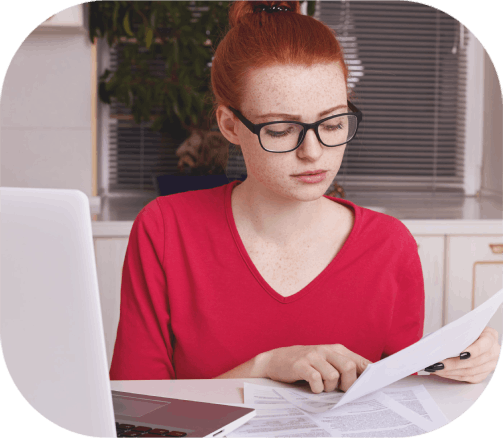 A student reviews multilingual transcript pages as Manchester Translation Services confirms names, dates, and stamps.