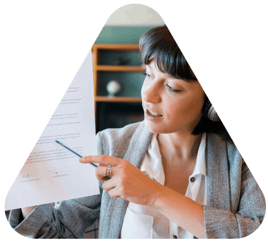 A translator compares an official record to a formatting checklist while Newport News Translation Services prepare compliant.