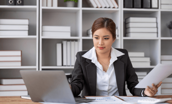 A native translator stamps and reviews certified documents at a desk, providing Translation Services in Fairfield
