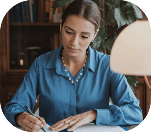 A translator reviews a handwritten note in a rare language as Newport News Translation Services refine multilingual wording.