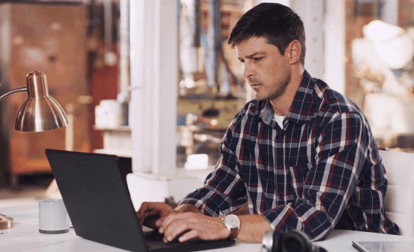 A specialist matches layout in a desktop publishing file, relying on Newport News Translation Services for secure formatting.