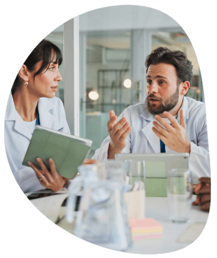 A client reviews requirements for pharmaceutical translation services across regions during an in-person meeting.