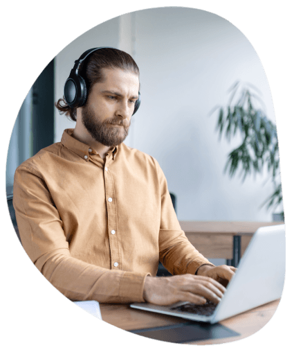 A project manager at Tulsa Transcription Services marks a rush delivery timeline on a screen while preparing files.