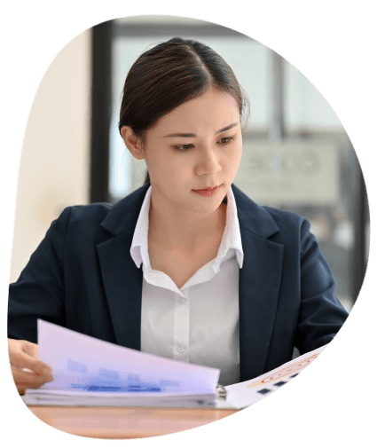 A quality specialist checks an ISO compliance checklist beside a translated report, showing business assurance.