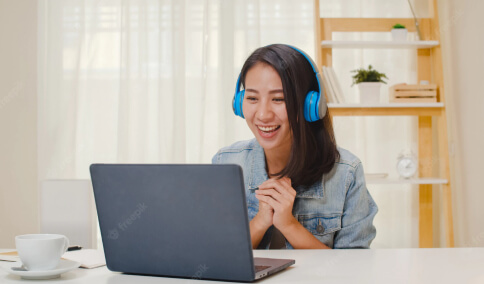 A student participating an online course with headphones on