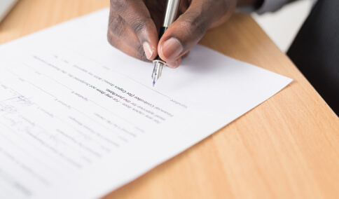 A man about to sign a contract document
