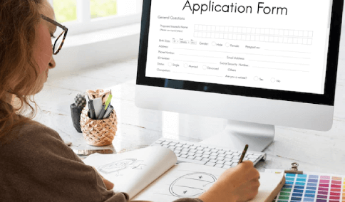 A student filling a scholarship application form on desktop
