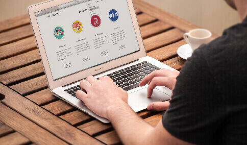 A translator working on website translation on a MacBook